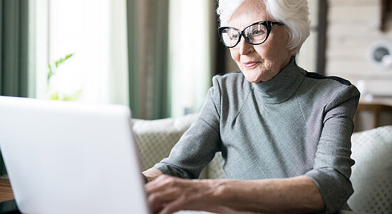 Senior woman typing on laptop